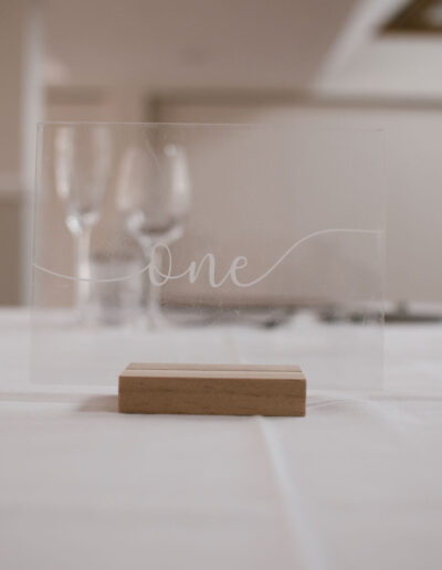 Clear acrylic table sign on wooden base