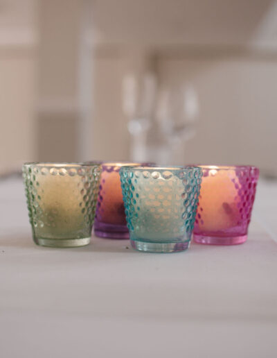 Four coloured hobnail glass votives with tealights