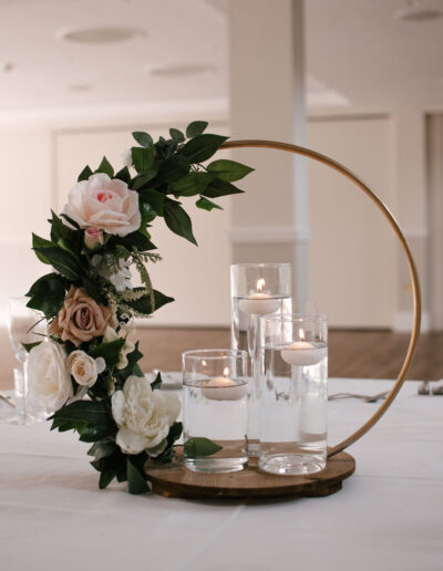 Gold hoop centrepiece with blush roses and floating candles