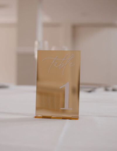 Gold mirrored acrylic table number with white script