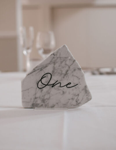 Marble table sign with black script