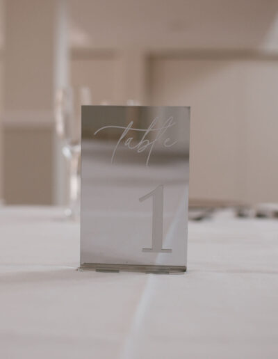 Silver mirrored acrylic table number with white script