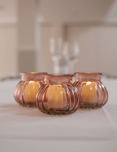 Three ribbed blush glass votives with tealights