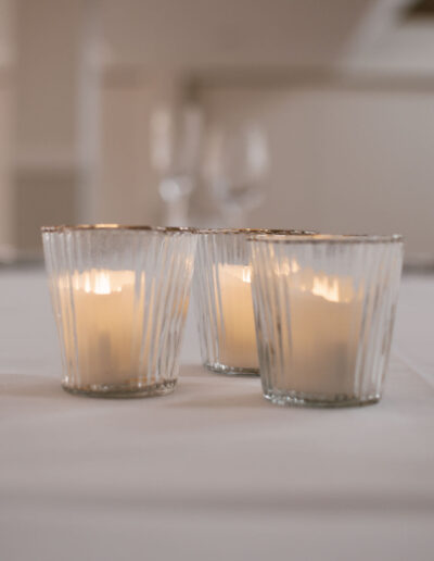 Three ribbed glass votives with gold rims