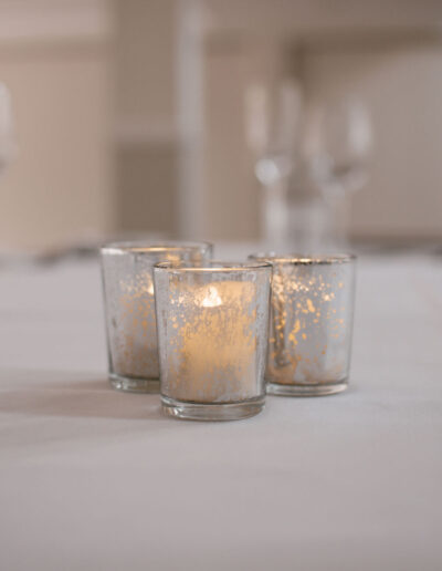 Three silver mercury glass votives with tealights