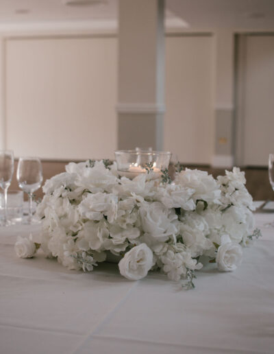 White rose and hydrangea centrepiece with glassware